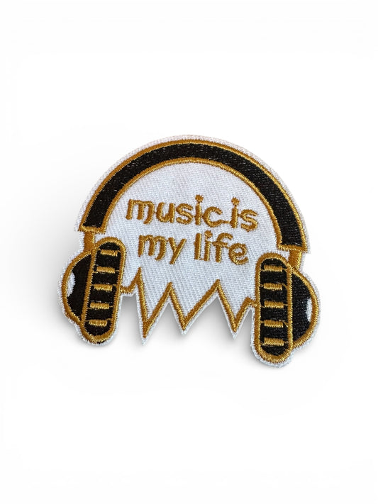 Patch with Music Is My Life text on a wooden background