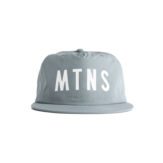 hat brim cap with the letters 'MTNS' printed in bold white across the front, shown against a plain white background. MTNS Mineral Blue Quick Dry Hat