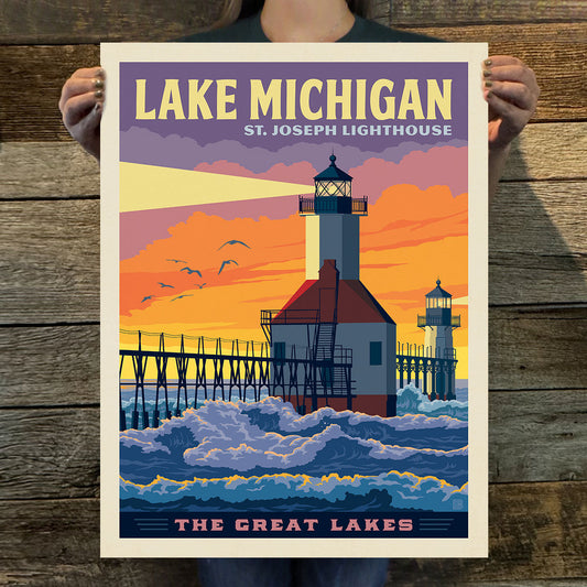 Poster of St. Joseph Lighthouse on Lake Michigan held by a person against a wooden background