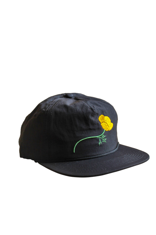 Black cap with a yellow flower design on a white background