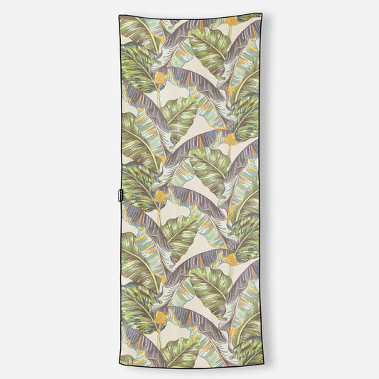 Tropical leaf patterned towel on a white background
