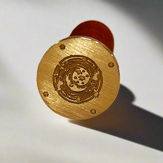 Gold circular object with intricate design on a white background