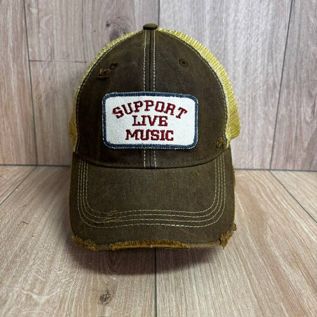 A distressed trucker-style baseball cap with a dark brown washed front and brim, yellow mesh side panels, and a white rectangular patch on the front that reads 'SUPPORT LIVE MUSIC' in red letters.