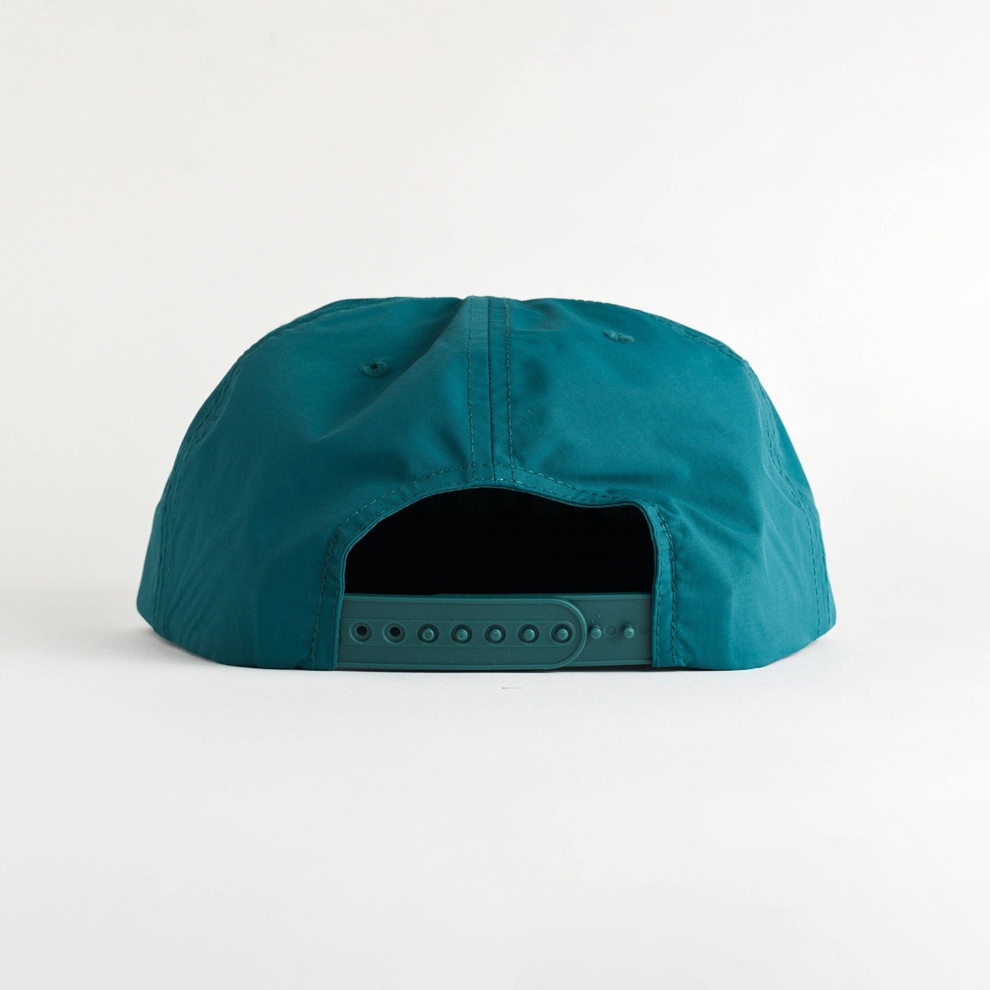 The back view of a teal snapback cap on a clean white background.