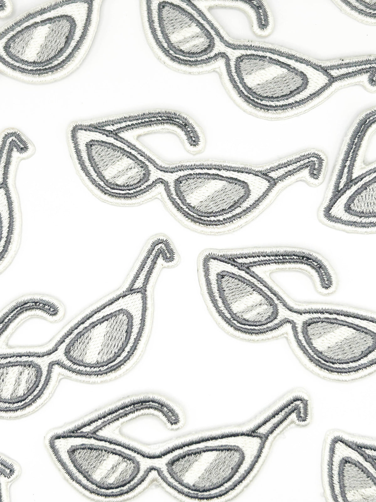 Pattern of sunglasses illustrations on a white background