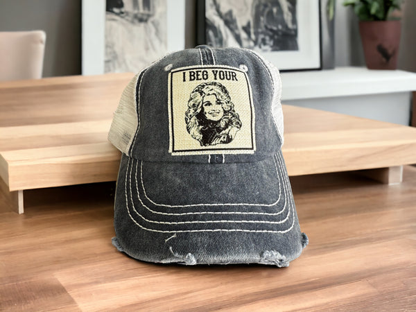 "I Beg Your (Parton)" Dolly Distressed Trucker Caps