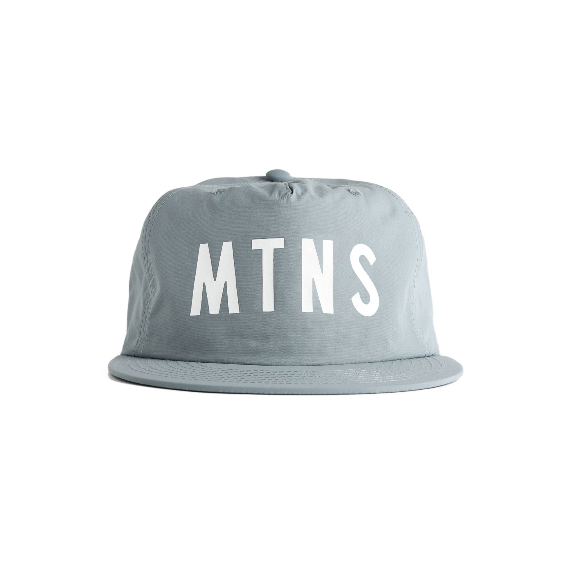 hat brim cap with the letters 'MTNS' printed in bold white across the front, shown against a plain white background. MTNS Mineral Blue Quick Dry Hat