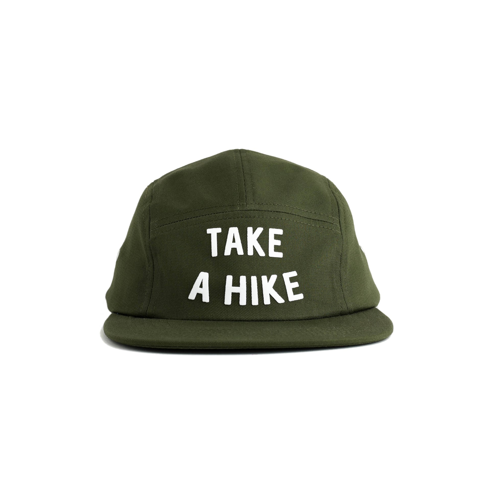 An olive green 5-panel cap with the phrase 'TAKE A HIKE' printed in bold white capital letters on the front, set against a plain white background.  Green hat reads "take a hike" in turquoise flocked lettering on a seam free front panel. 