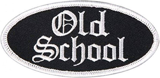 An oval embroidered patch with a black background and white gothic-style lettering that reads 'Old School' on a white background.