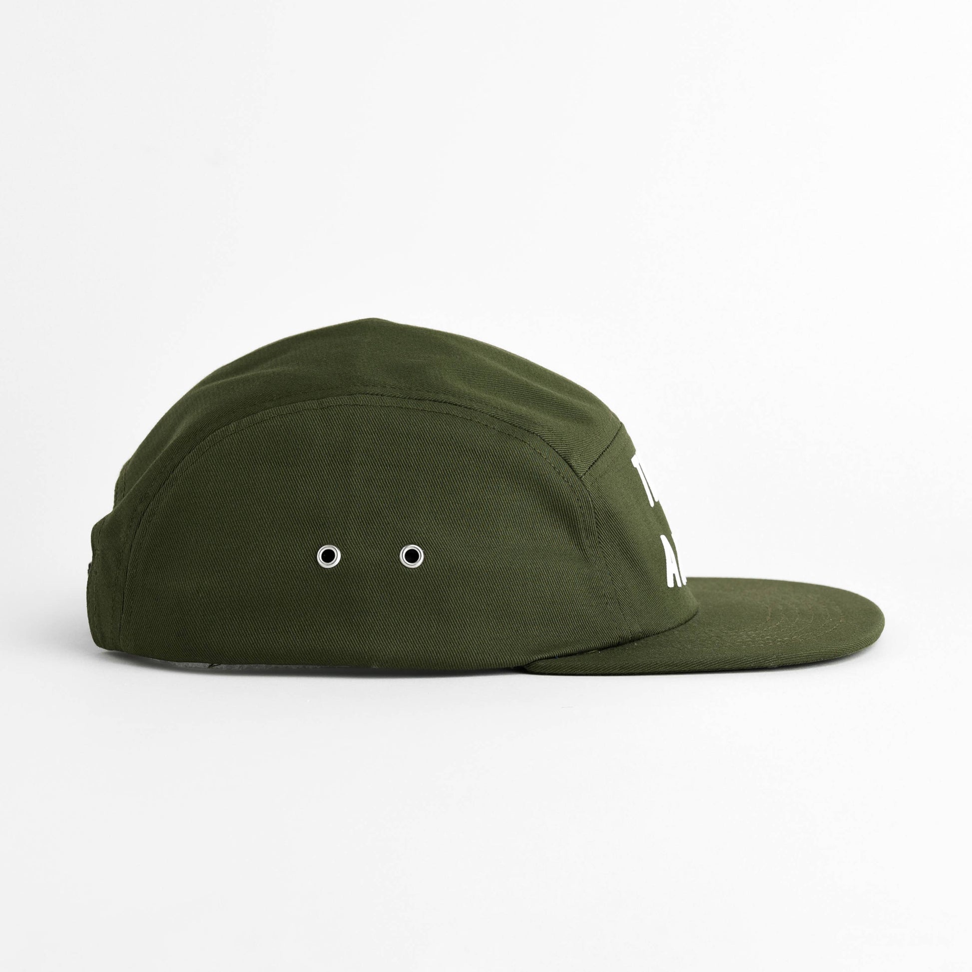 An olive green five-panel cap with a flat brim, featuring two metal eyelets on the front and a small white embroidered logo on the side, set against a plain white background.  Green hat reads "take a hike" in turquoise flocked lettering on a seam free front panel. 