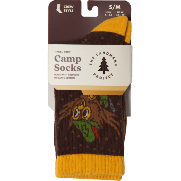 Packaged camp socks with owl design and 'The Landmark Project' branding on a white background.