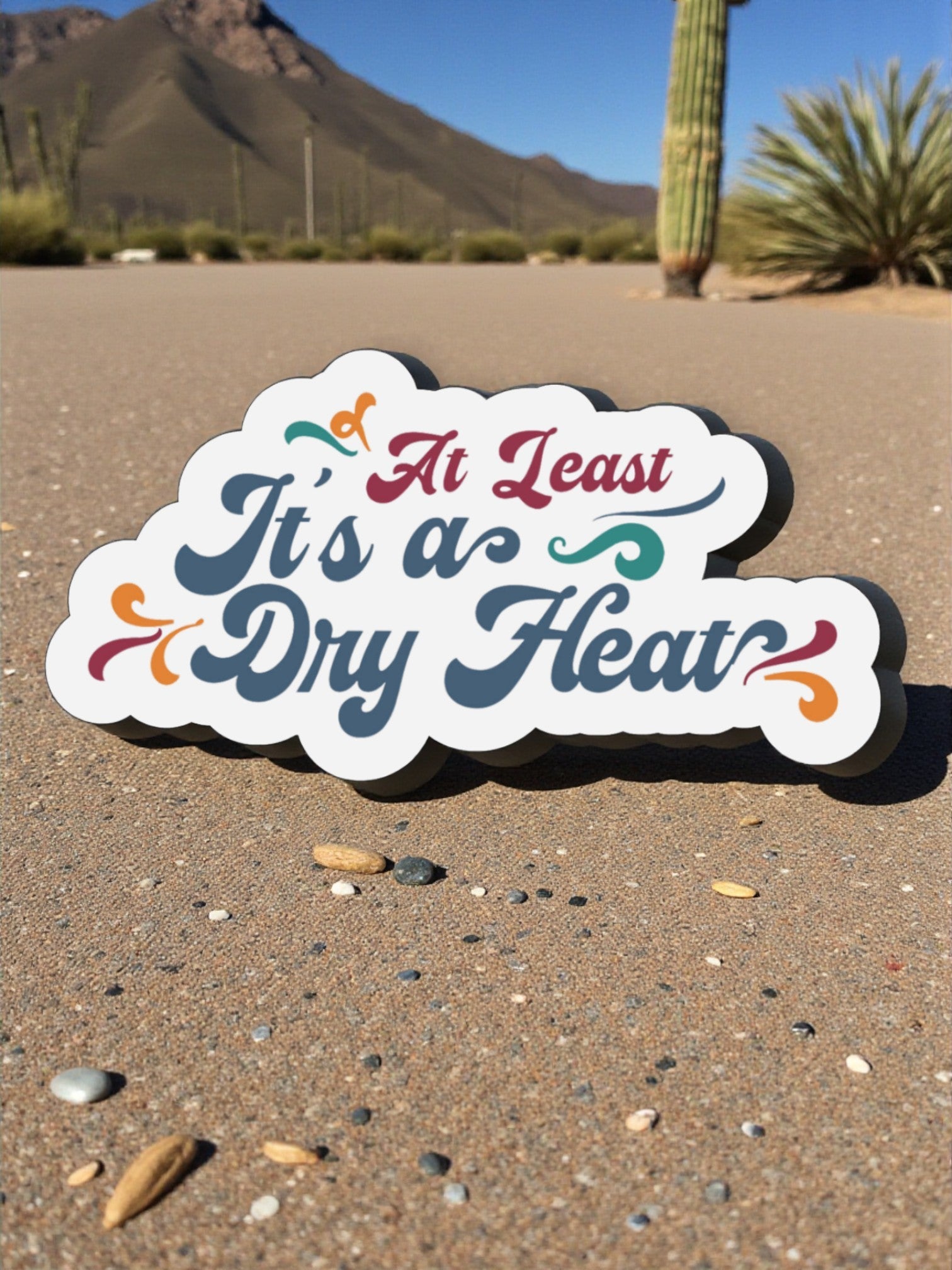 "At Least It's A Dry Heat" Vinyl Sticker 3" Wide - Wander Together Outfitters