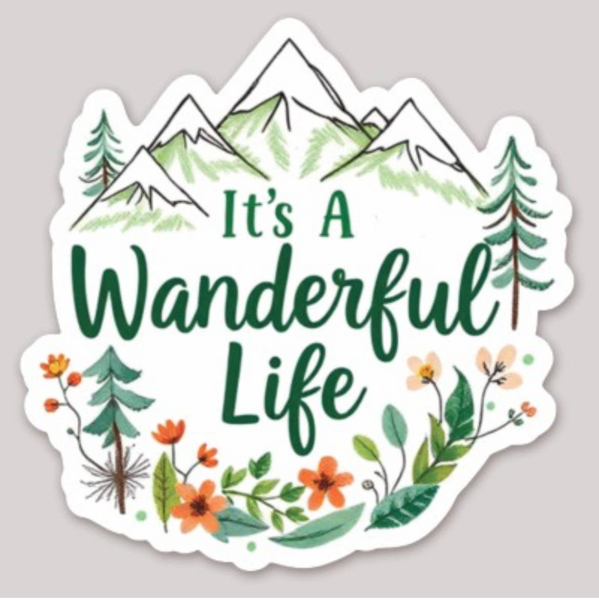 A die-cut sticker featuring a hand-drawn mountain landscape with the phrase 'It's A Wanderful Life' in green script, surrounded by green pine trees and orange wildflowers on a white background.