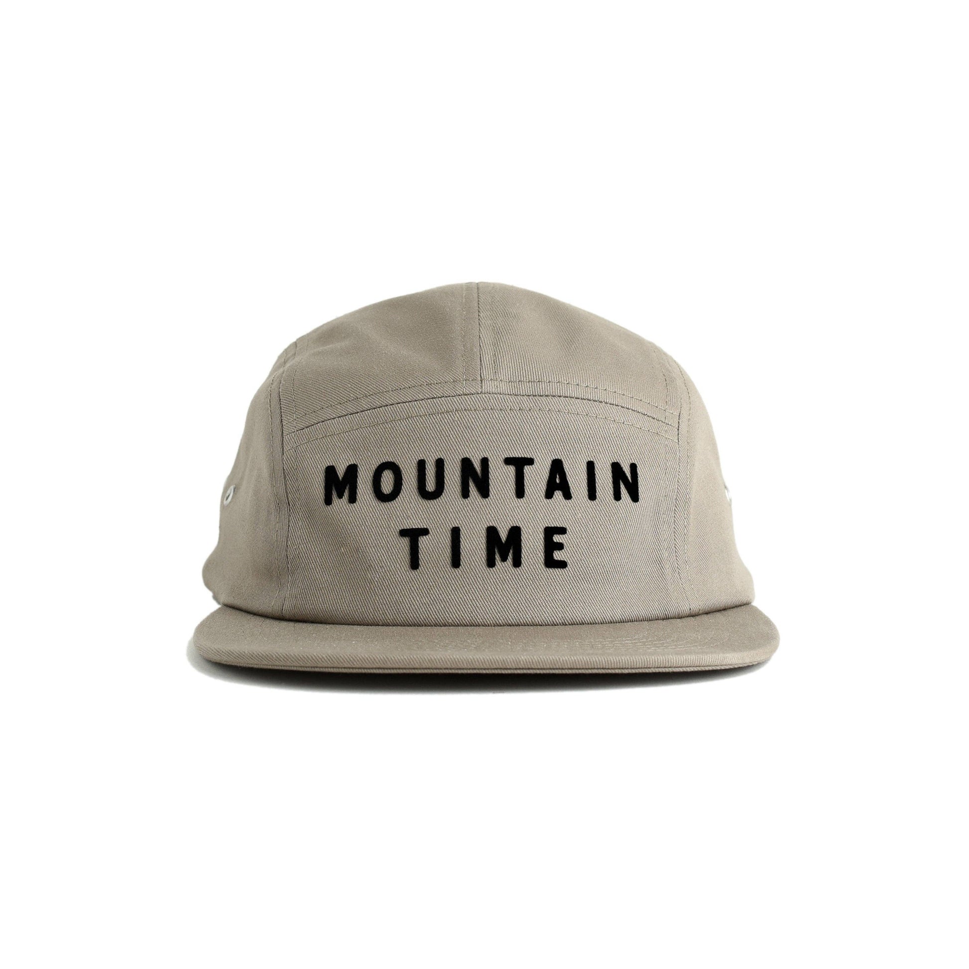 A light beige 5-panel cap with 'MOUNTAIN TIME' embroidered in black block letters on the front, shown against a plain white background.