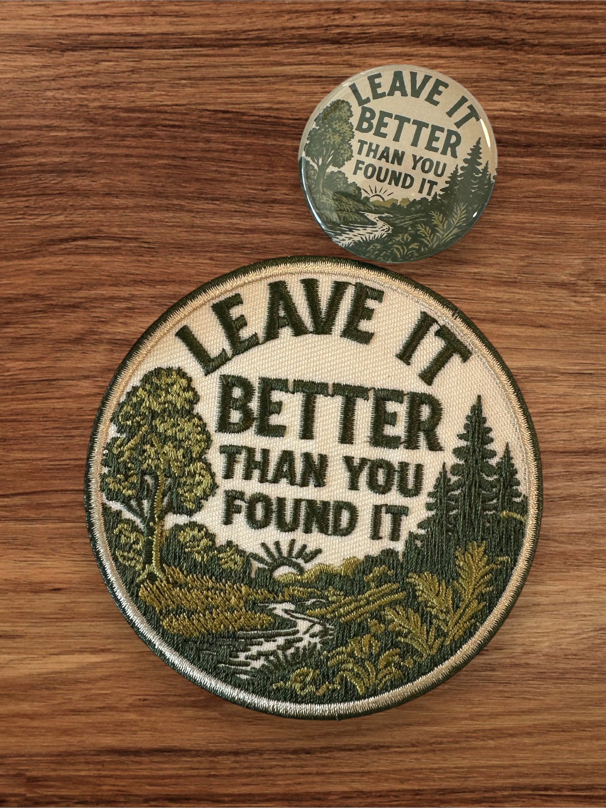 Round patch and button with 'Leave it better than you found it' text on a wooden surface