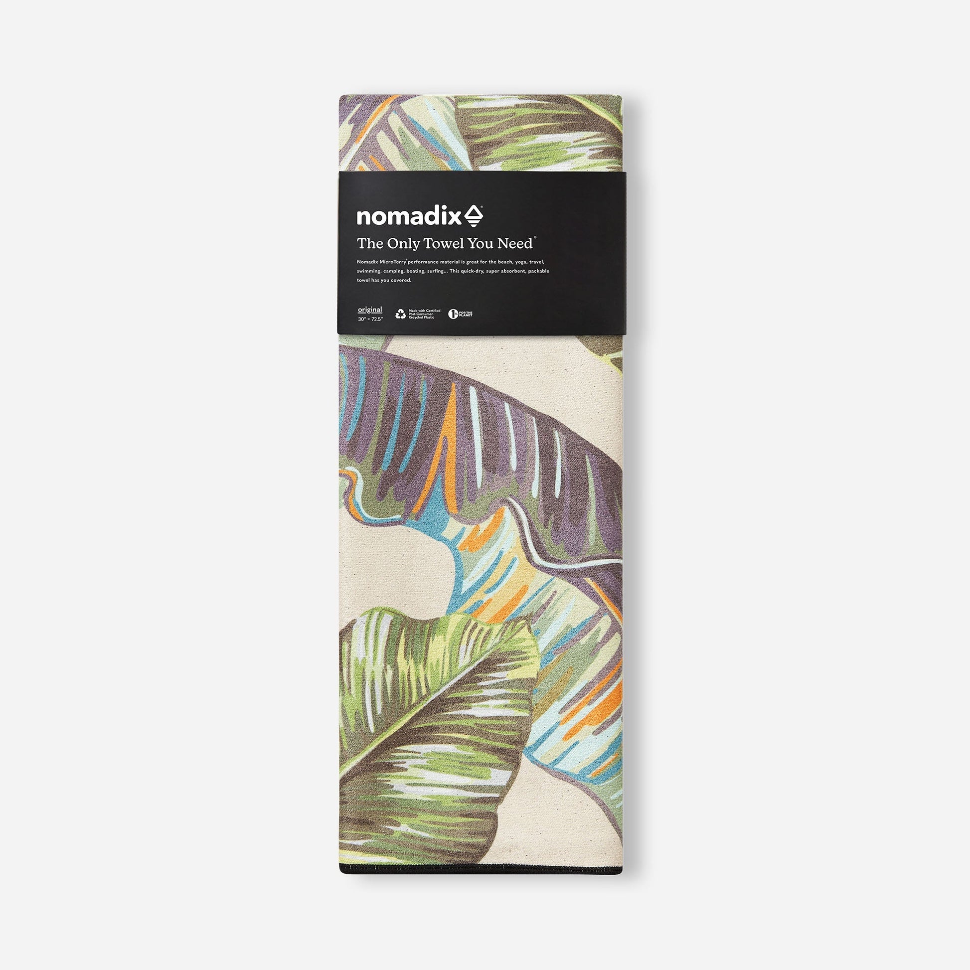 Packaged towel with colorful leaf design and Nomadix branding on a white background