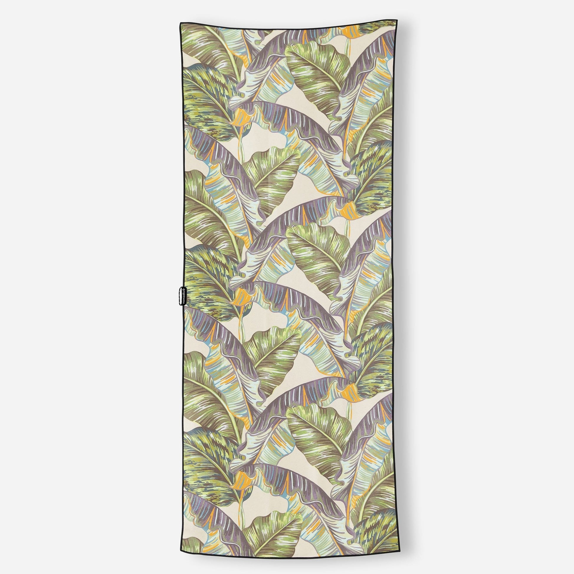 Tropical leaf patterned towel on a white background