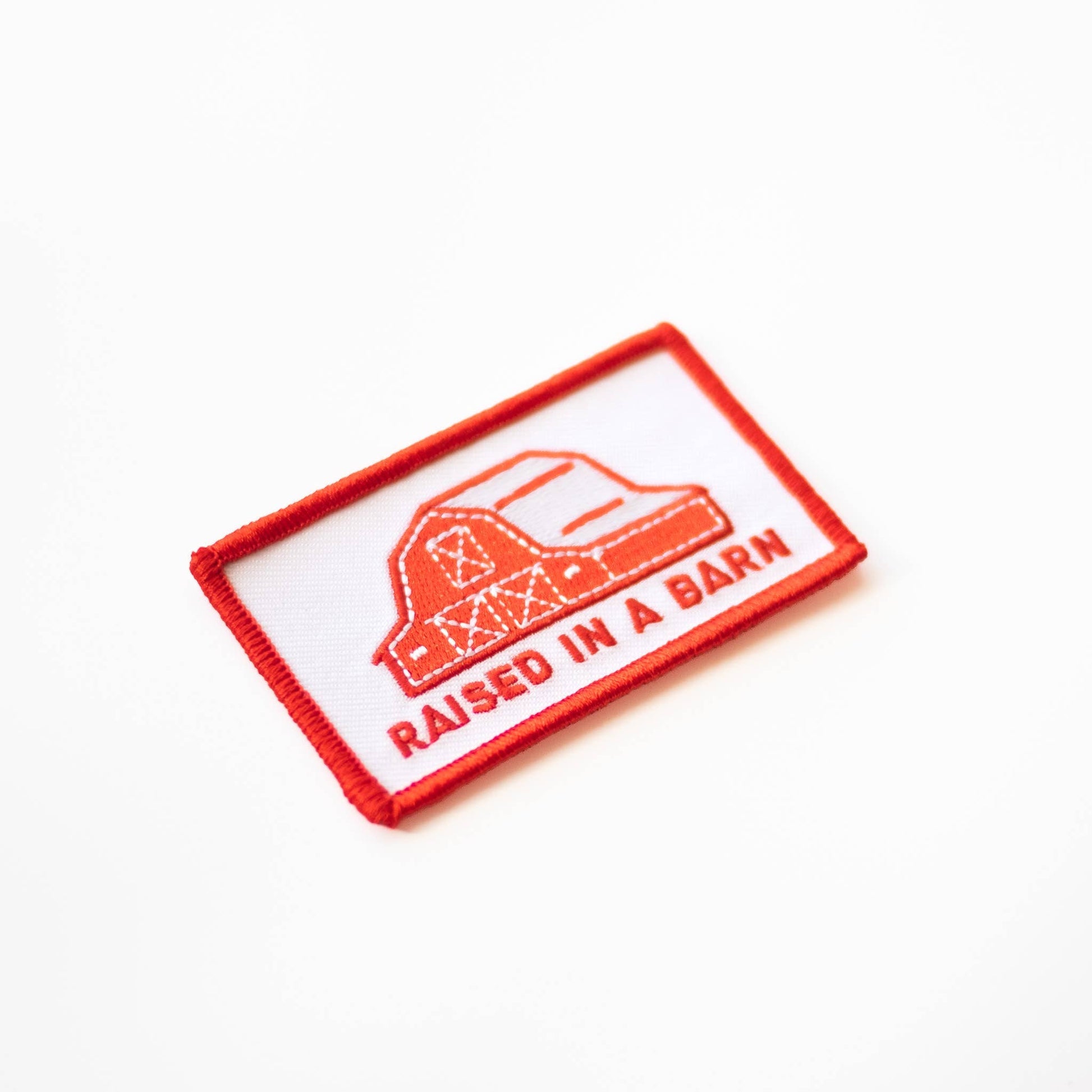 “Raised In A Barn” Embroidered Iron on Patch - Wander Together Outfitters