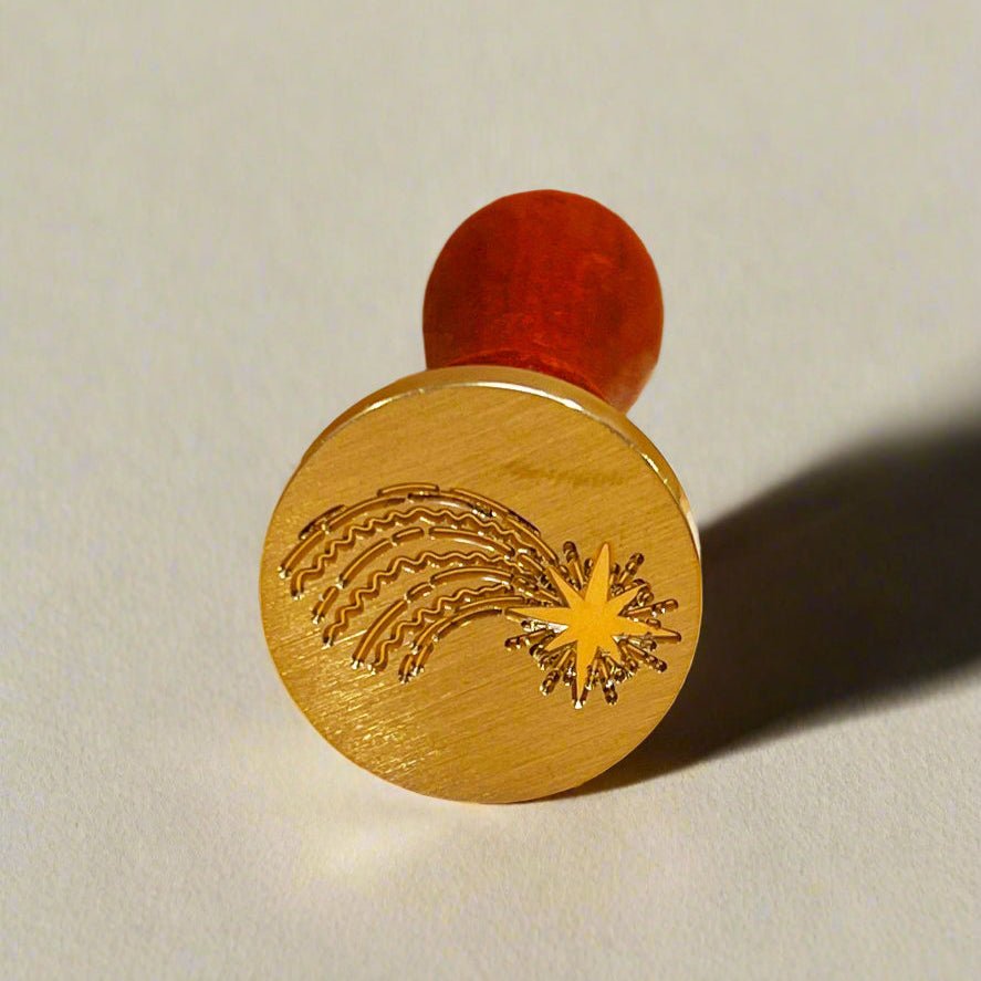 Decorative wooden stamp with a red handle on a beige background