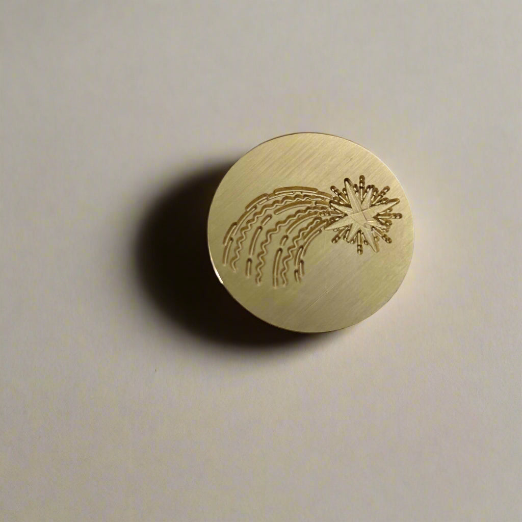 Gold circular object with engraved design on a light gray background