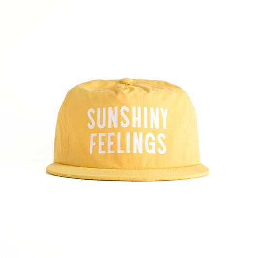 Yellow bucket hat with 'SUNSHINY FEELINGS' text on a white background
